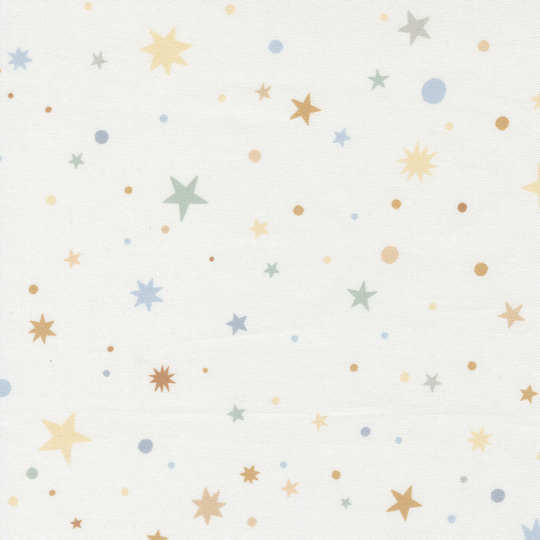 fabric swatch with various sizes of stars, starbursts, and dots in soft yellows, blues, greens, and browns, on a soft white background
