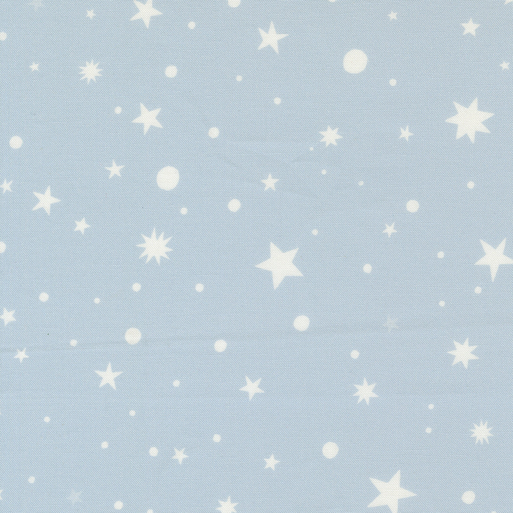 fabric swatch with various sizes of stars, starbursts, and dots in soft white, on a soft blue background