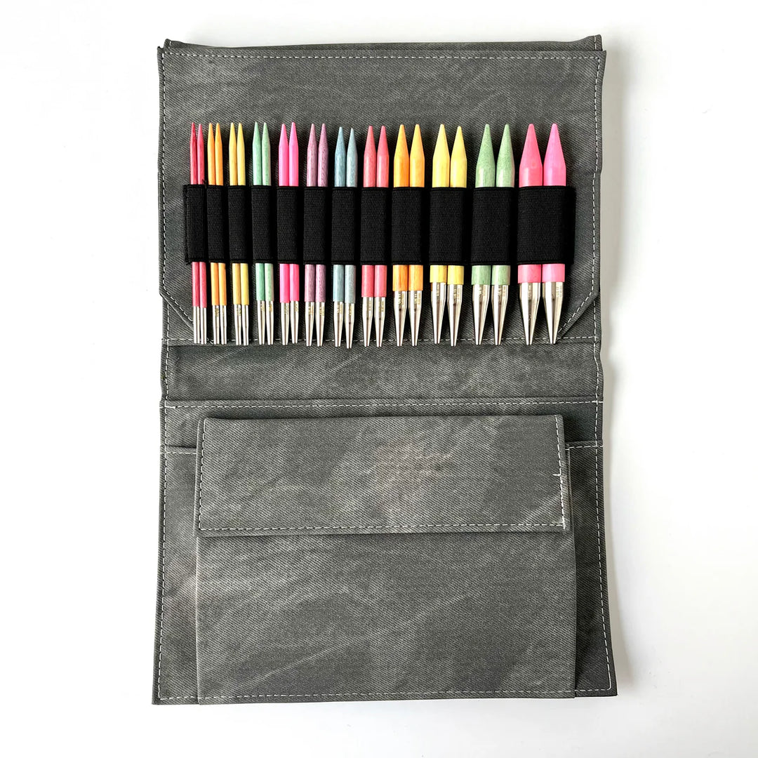 Grey denim carrying case with colorful wooden knitting needles