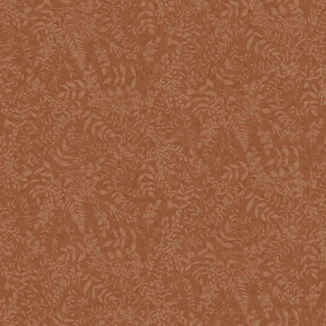 swatch of a rust colored fabric printed with a light colored print of various greenery shapes