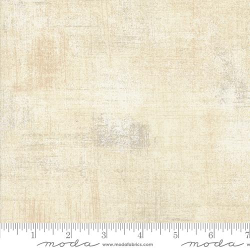 Textured beige fabric swatch with a ruler at the bottom for scale, featuring the Moda Fabrics logo.