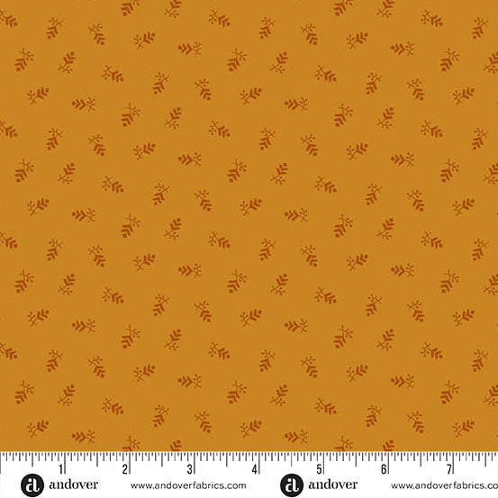fabric swatch with a geometric print of small pine cone clusters in dark orange all on a lighter orange background