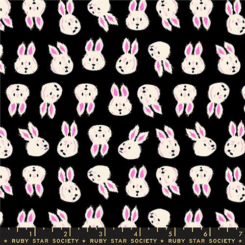 print featuring white rabbit heads with various facial expressions and in various orientations on a black background