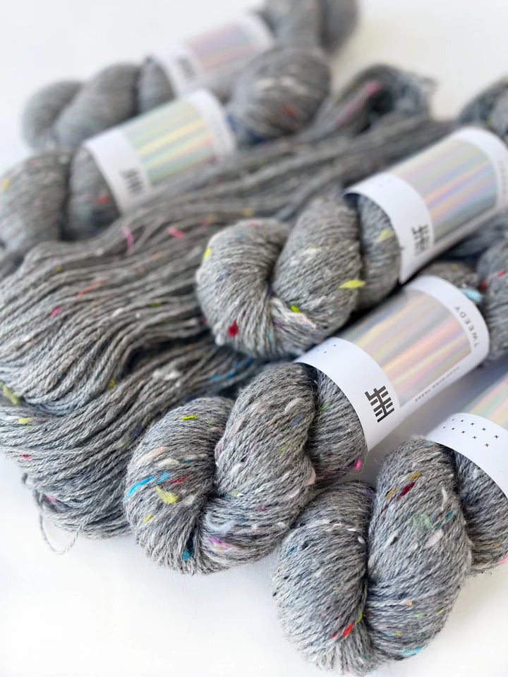 Grey Tweedy yarn with blue, yellow, red, and green