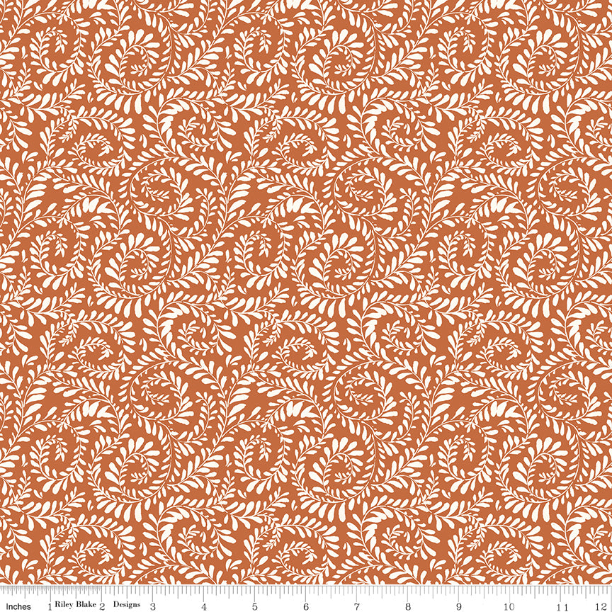 Brown background with white swirls of leaves