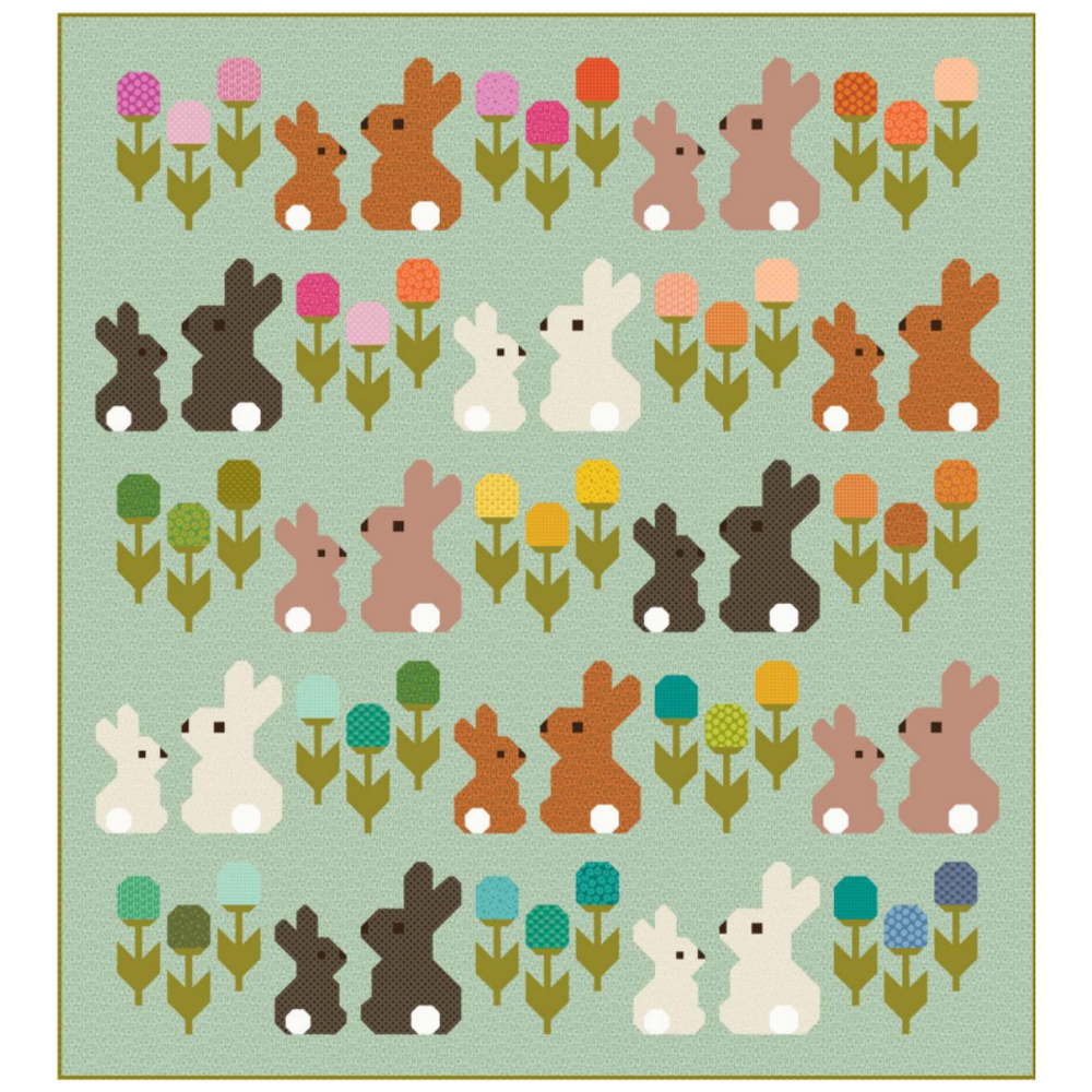 Quilt with bunnies and flowers on a light green background