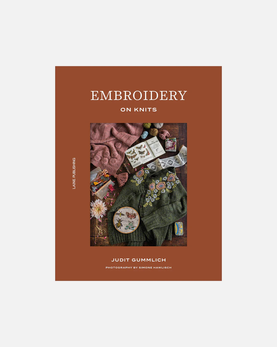 Book cover of 'Embroidery on Knits' with images of embroidered knits on a brown background