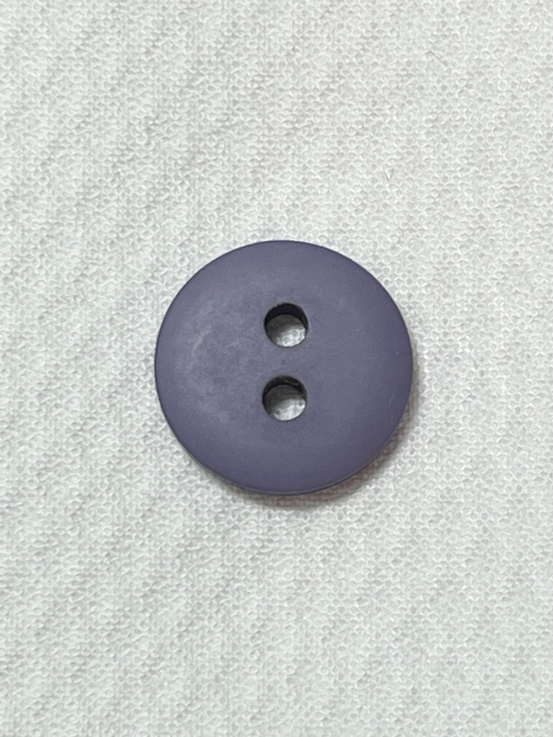 Purple button on a textured gray background