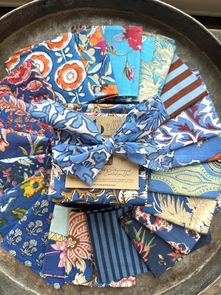 Collection of colorful fabric swatches on a metal tray