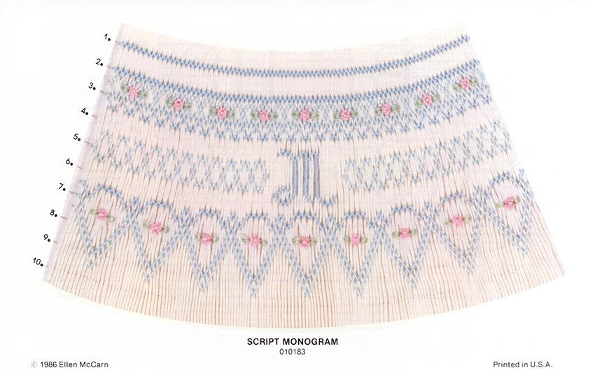 Embroidered fabric sample with a script monogram on a white background