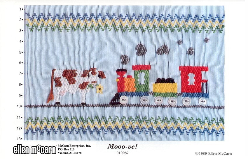 Smocking plate with a cow and a train with button wheels. 13 rows of smocking