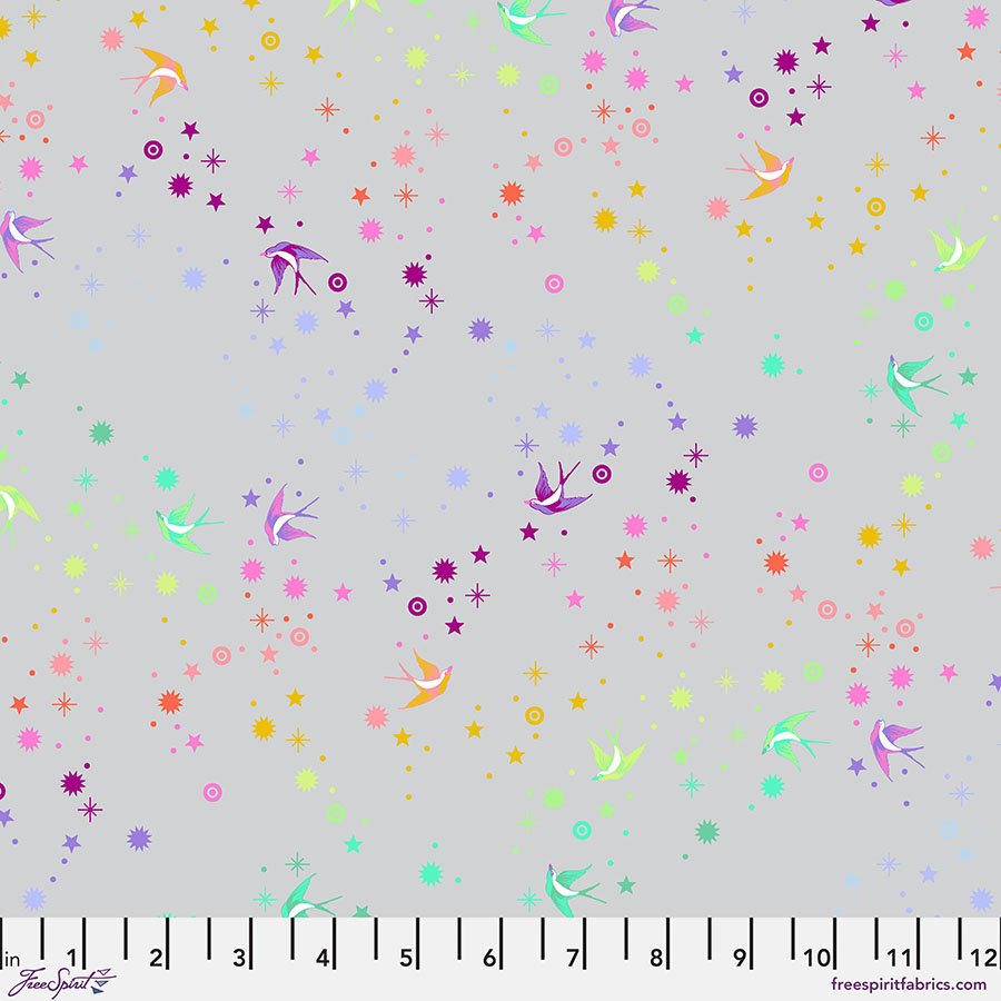 fabric swatch with a light gray background with various shapes of birds and stars in a rainbow gradient