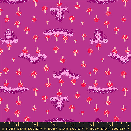 a print of purple caterpillars in various positions with small red and white mushrooms on a berry purple background