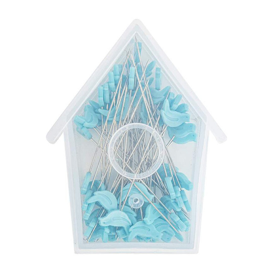Clear plastic container with blue bird sewing pins on a white background