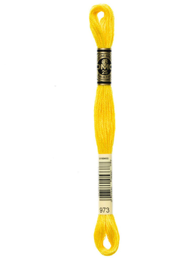 Yellow embroidery floss skein with a label on a white background