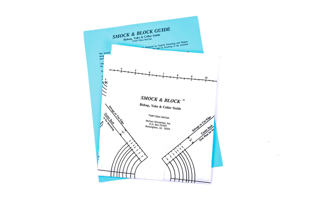 A Smock & Block Guide tool for bishop dress and blouse necklines laid out on a flat surface, with markings for various neck sizes.