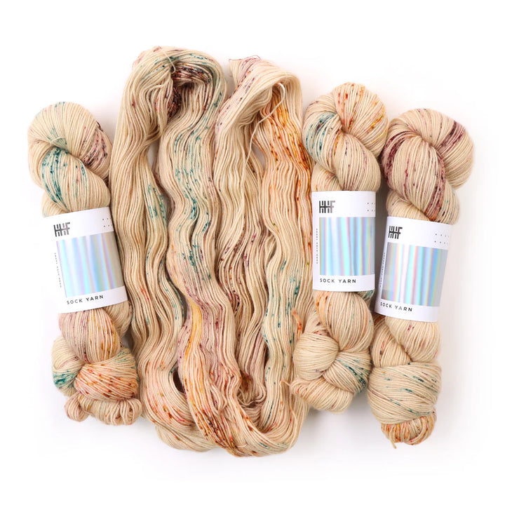 Sock Yarn. Tan with hints of purple, orange, and blues