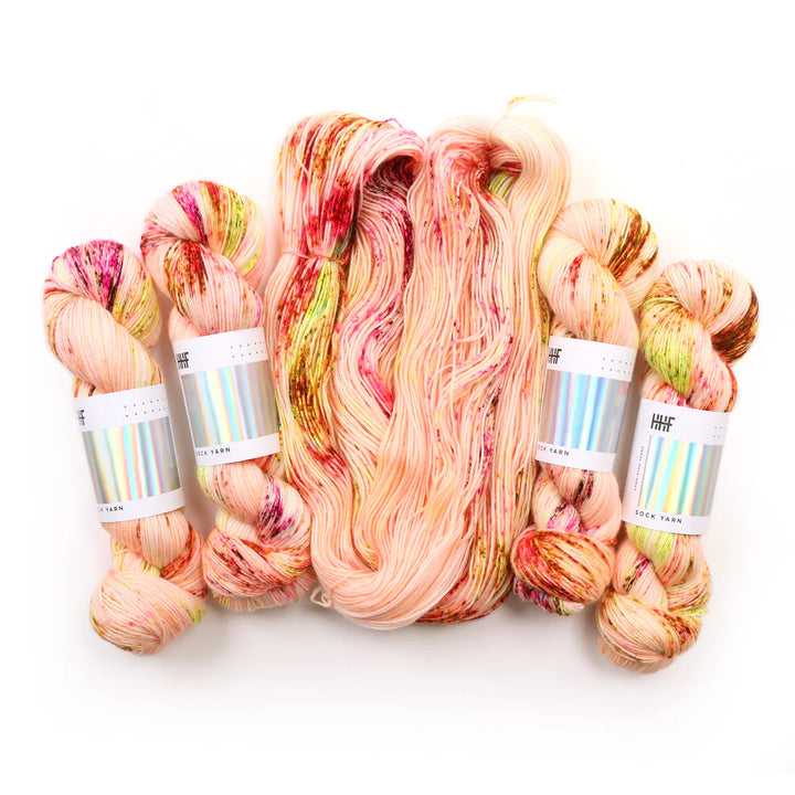 Sock yarn with hints of pinks, yellows, greens, and browns