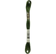 A skein of dark hunter green floss thread, with a label indicating the color and brand.
