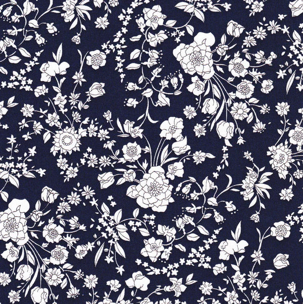 A patterned fabric featuring a floral design with various flowers in a navy blue color.