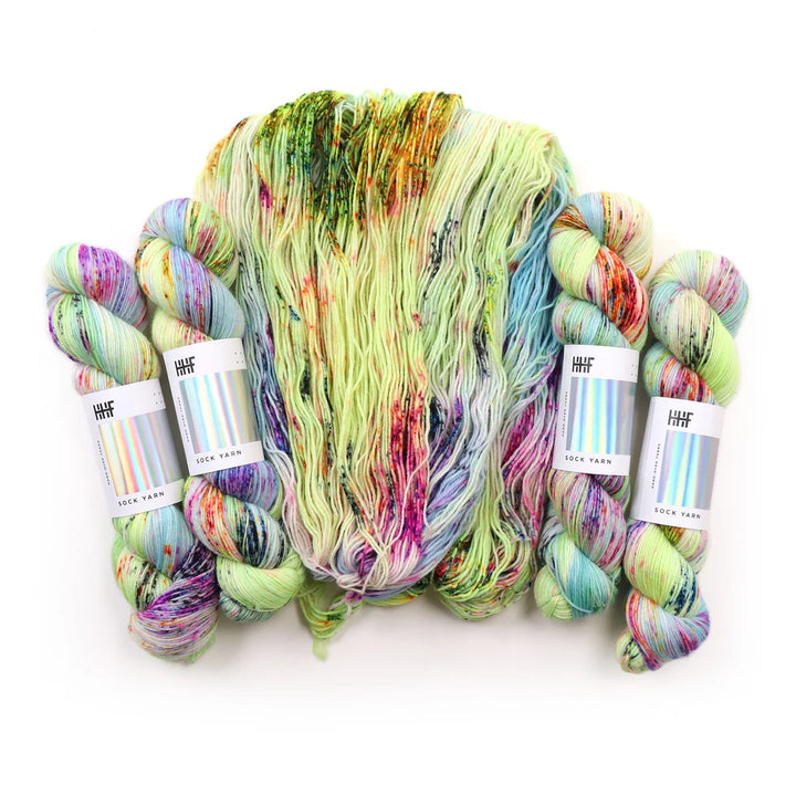 Sock yarn with hints of purple, green, blue, and pinks