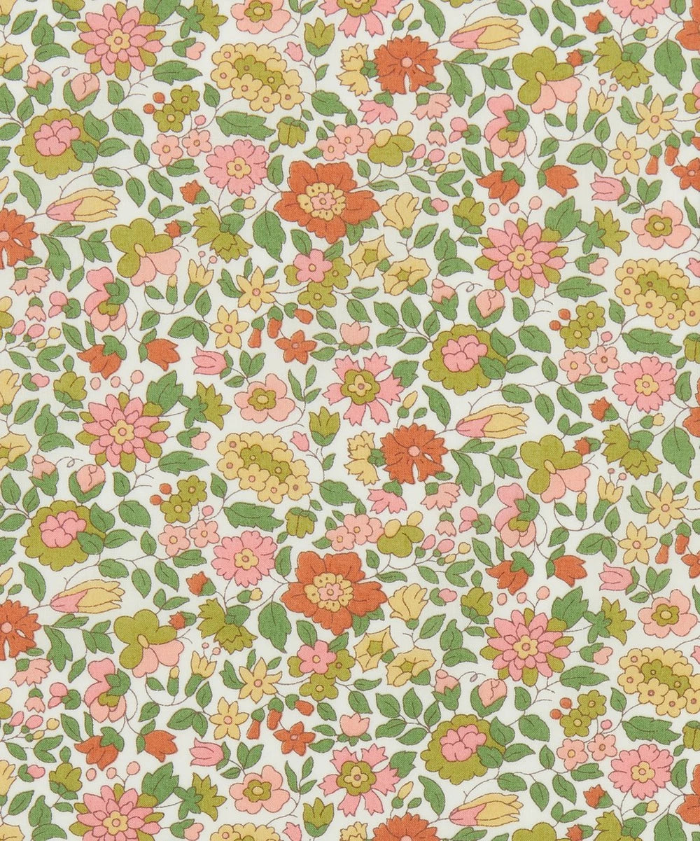 A patterned fabric featuring a multicolor floral design on a white background.