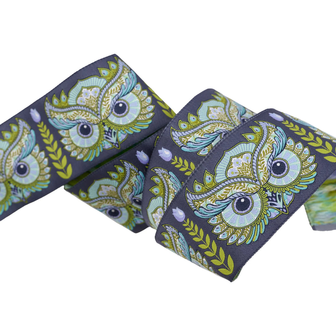 dark blue ribbon with an ornate owl design
