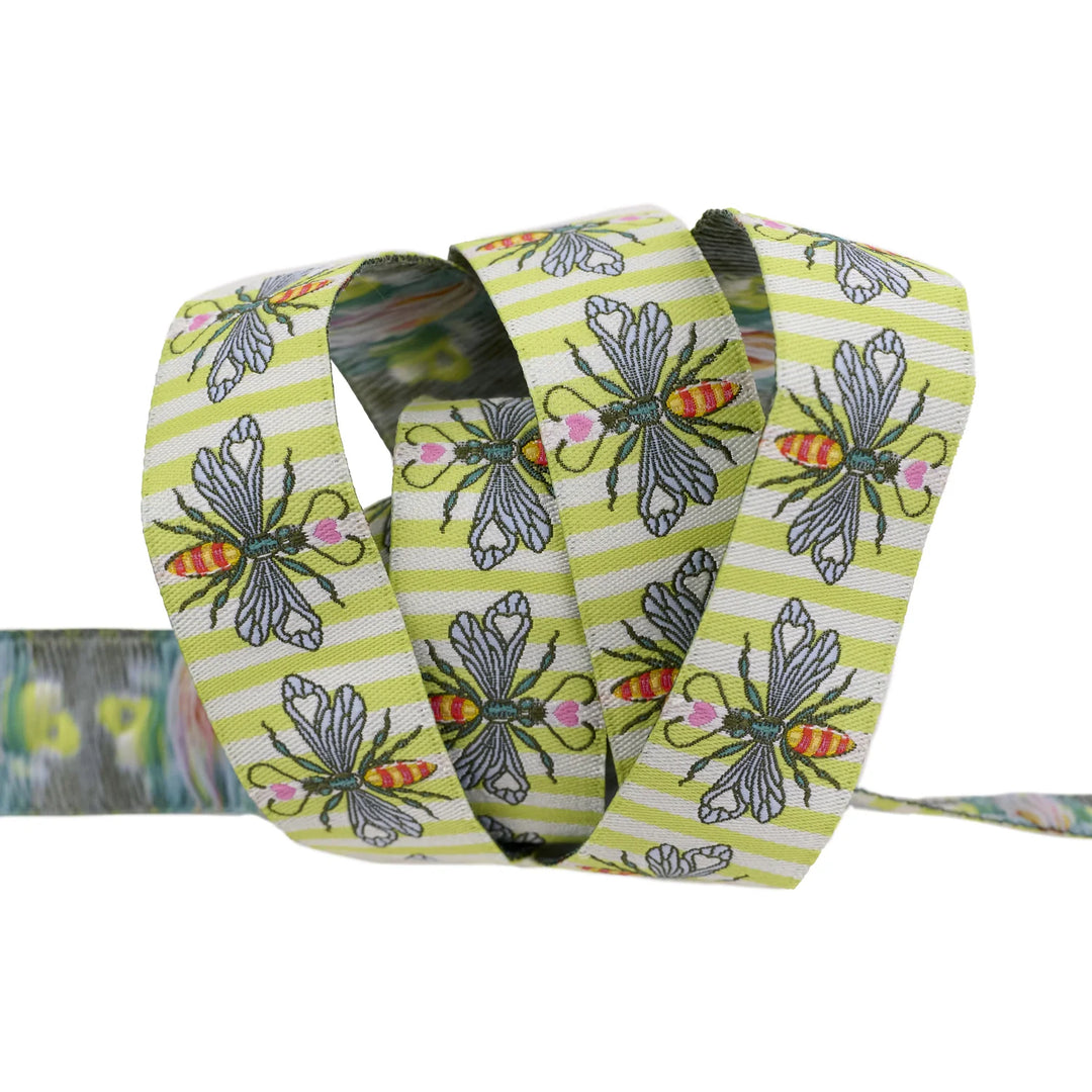 light green striped ribbon with an ornate bee design
