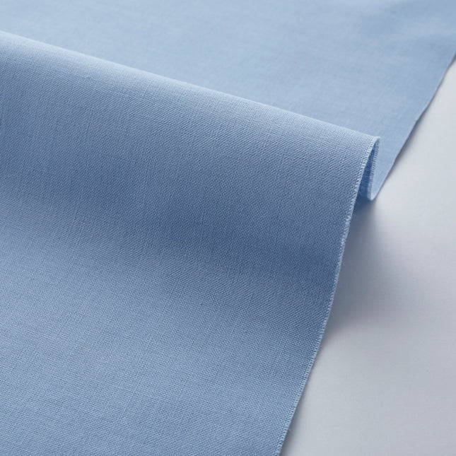 Close-up of light blue fabric on a white background