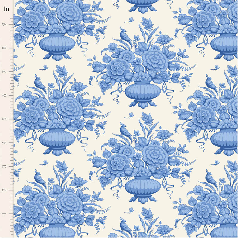 Blue floral and bird pattern on a white background with a fabric yardstick for scale.