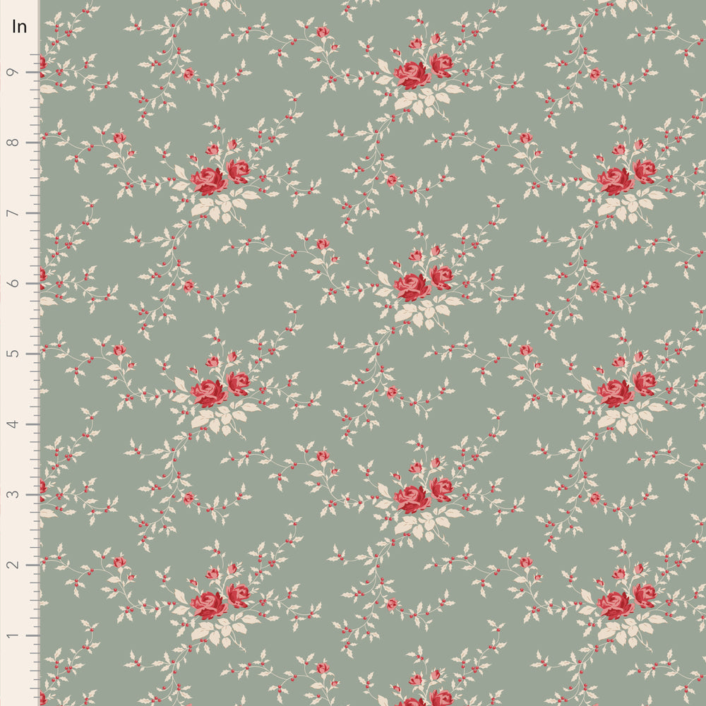 Floral pattern fabric with red and white flowers on a green background, measured against an inch ruler.