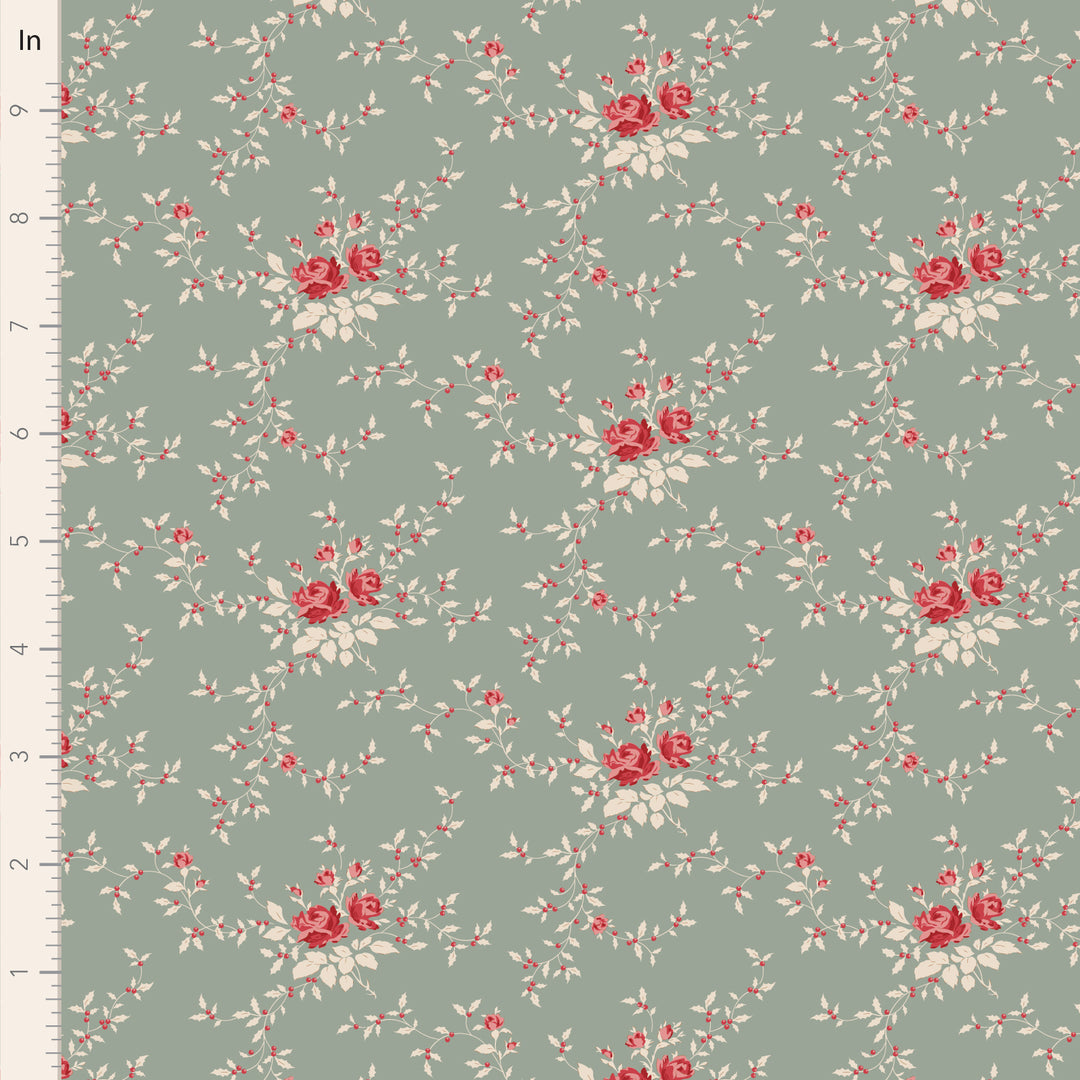 Floral pattern fabric with red and white flowers on a green background, measured against an inch ruler.
