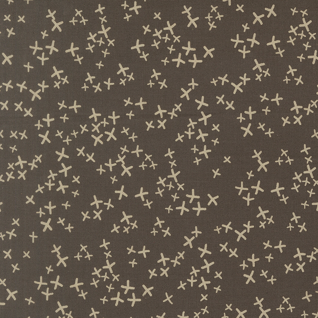 Pattern of white crosses on a brown background