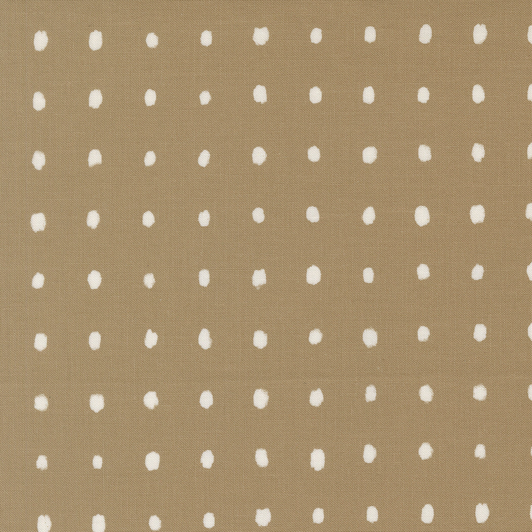 Pattern of white polka dots on a beige background