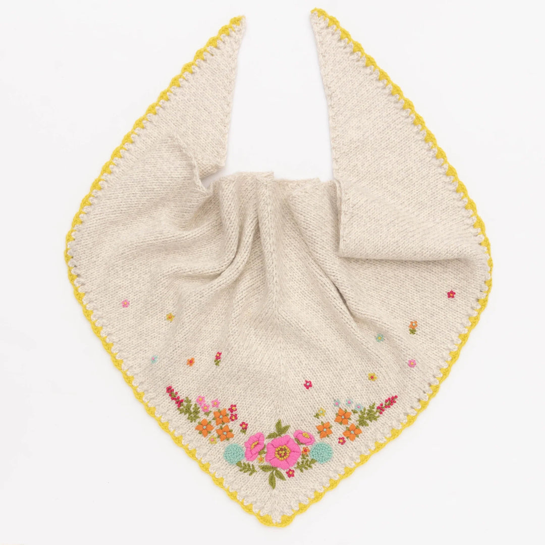 Knitted shawl with floral embroidery on a white background