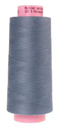 Large spool of blue thread on a white background