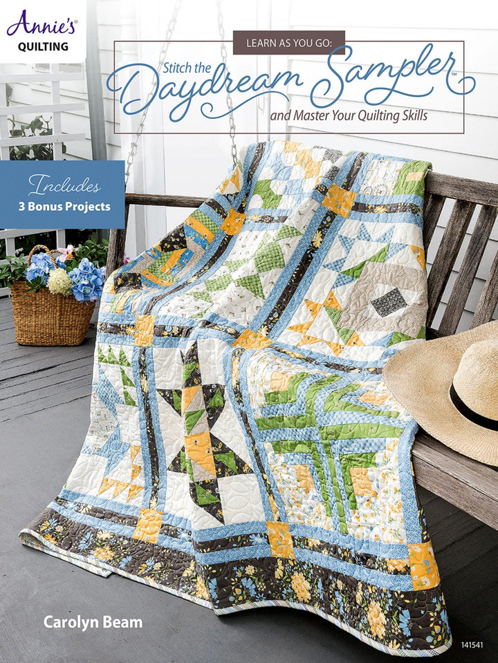 Quilt on a chair with 'Annie's Quilting' and 'Daydream Sampler' text.