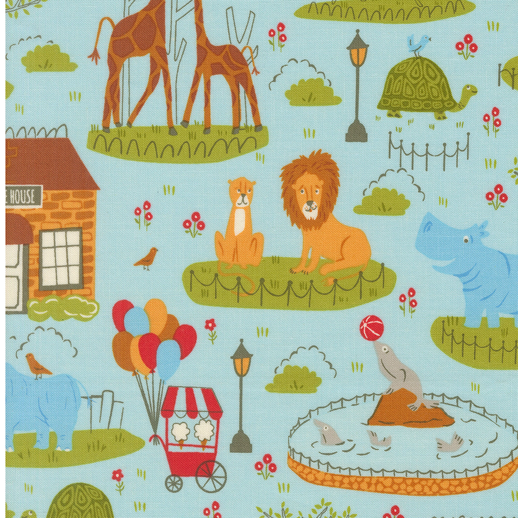 Patterned fabric with zoo animals and elements on a blue background