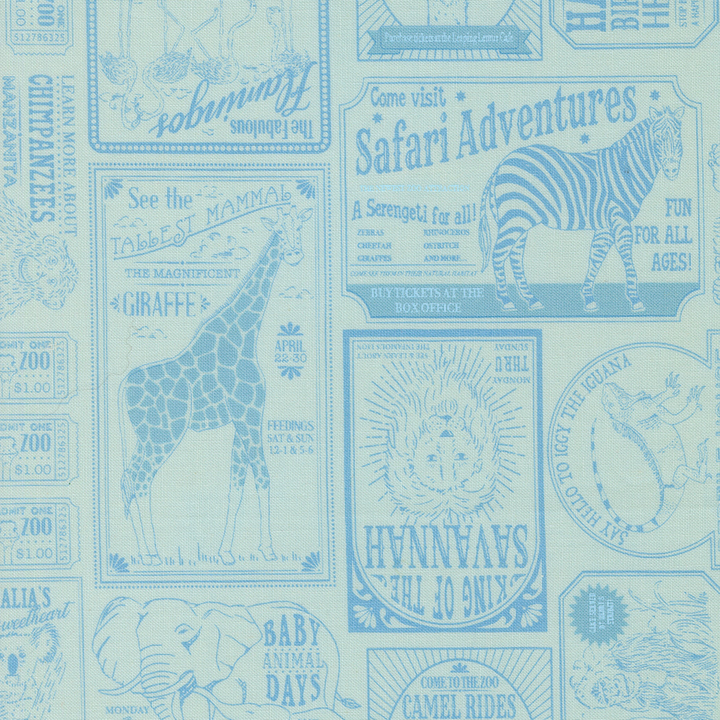 Patterned fabric with safari-themed text and animal illustrations on a light blue background.