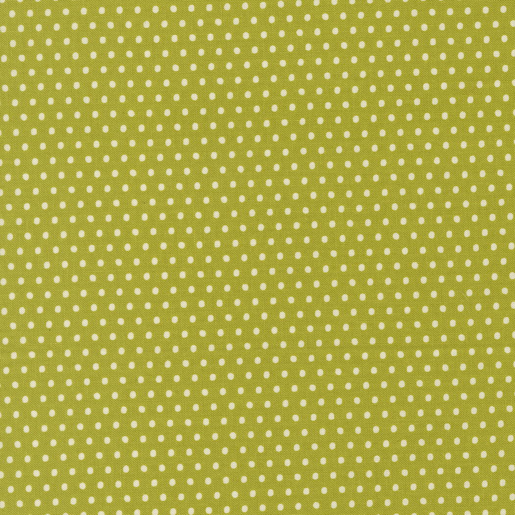 Green fabric with small white polka dots