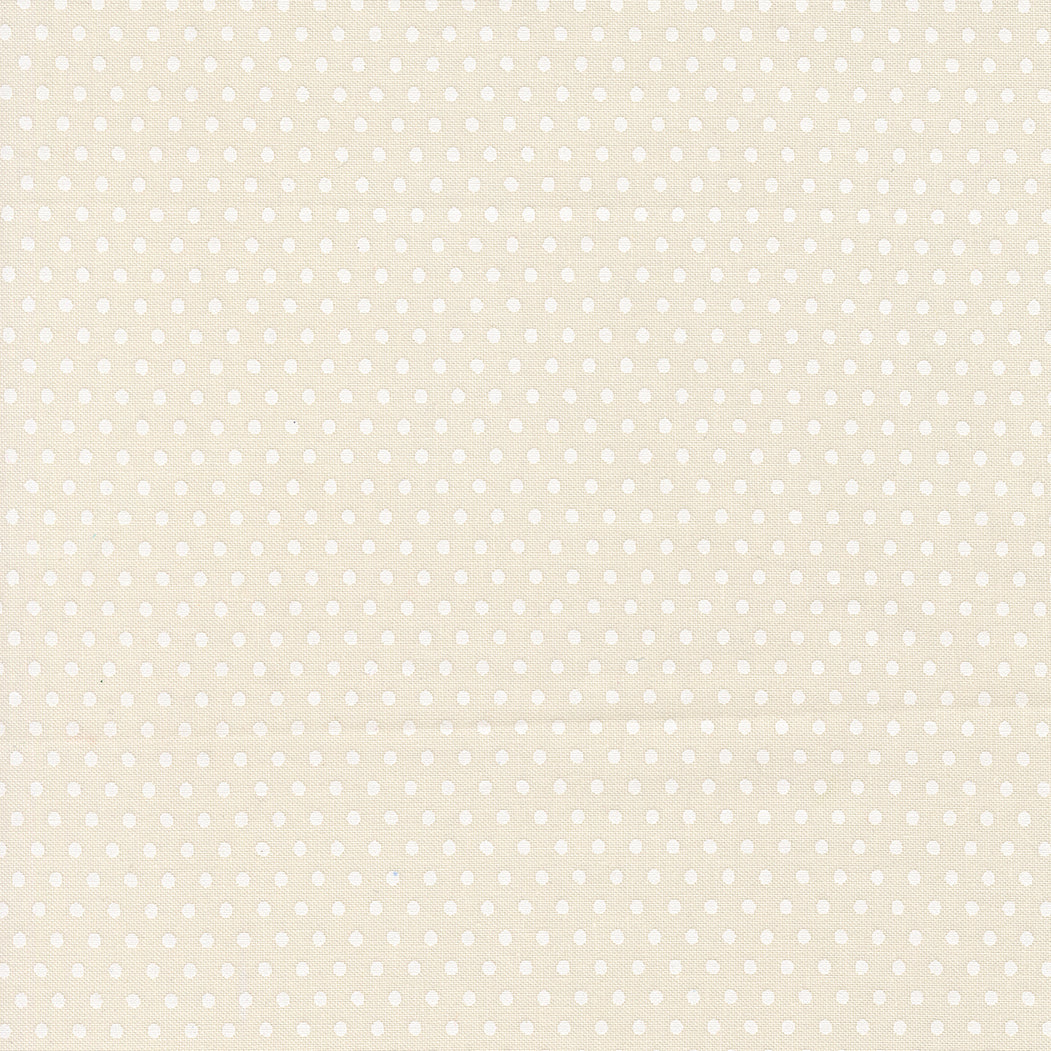 Pattern of small white polka dots on a beige background