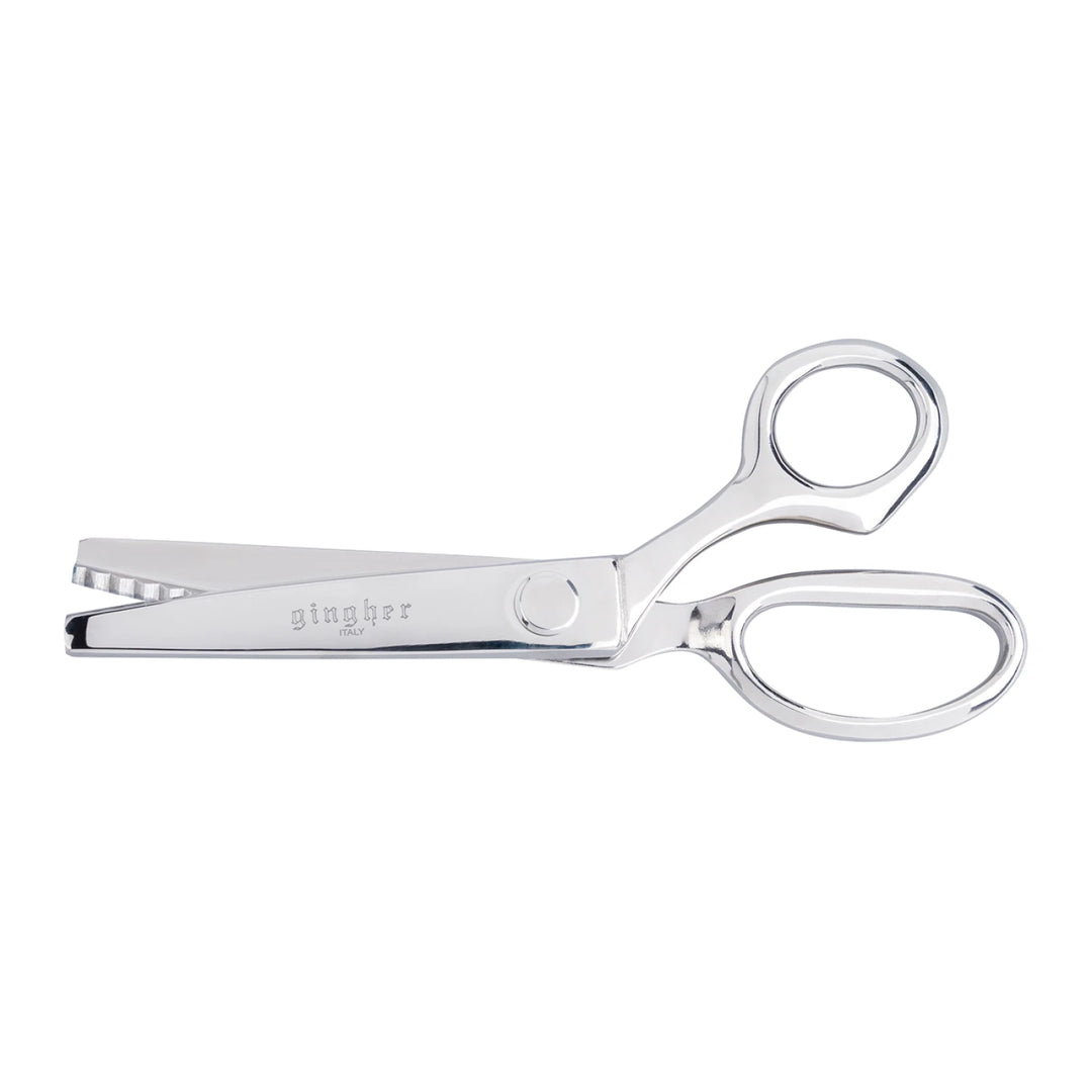 Metallic scissors with 'Gibson' branding on a white background