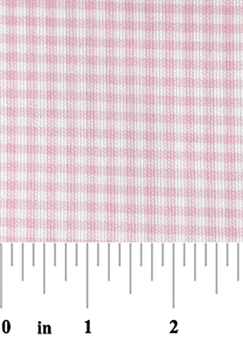 Pink and white checkered fabric with a ruler at the bottom for scale.