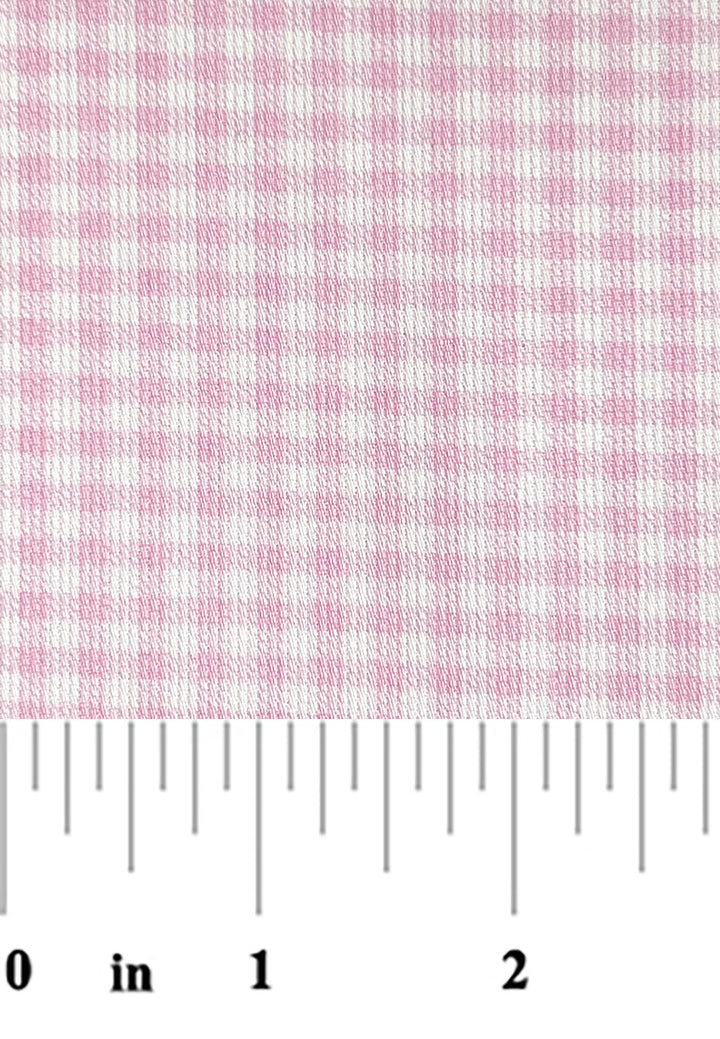 Pink and white checkered fabric with a ruler at the bottom for scale.