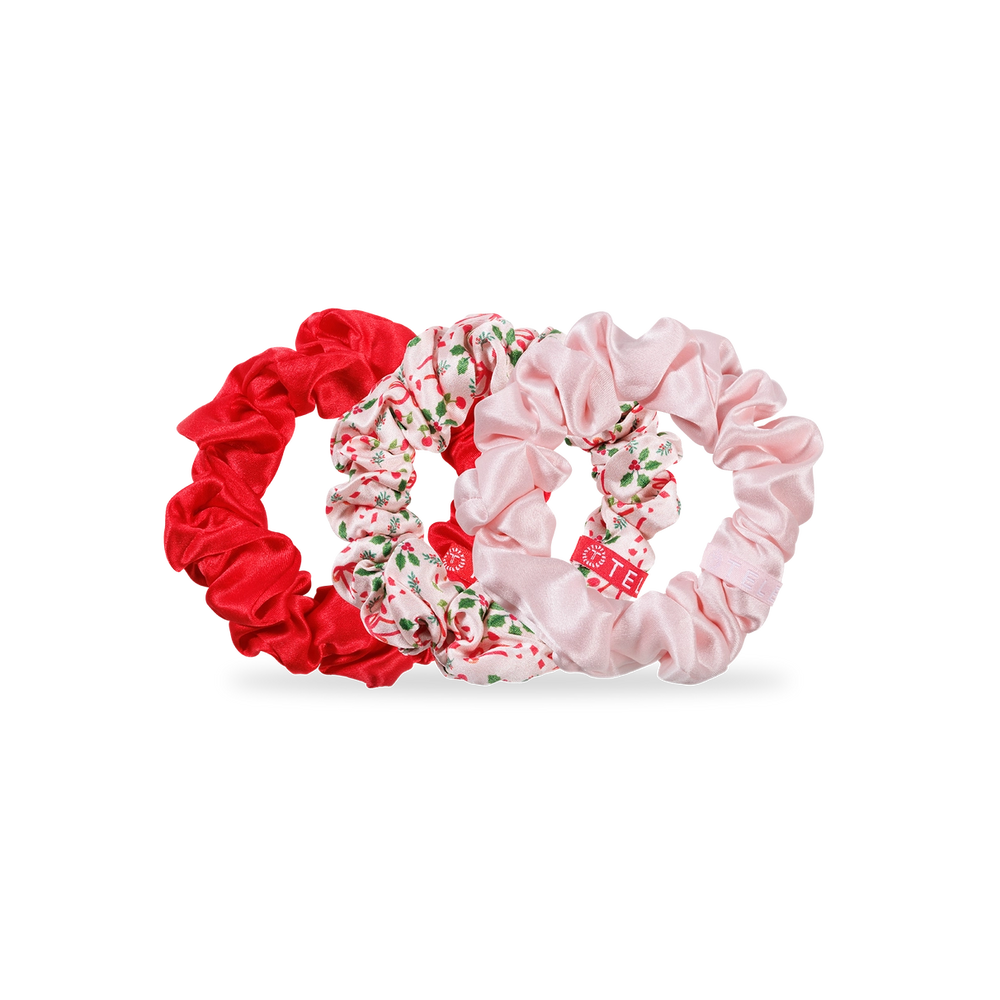 Set of three scrunchies in red, floral, and pink on a white background