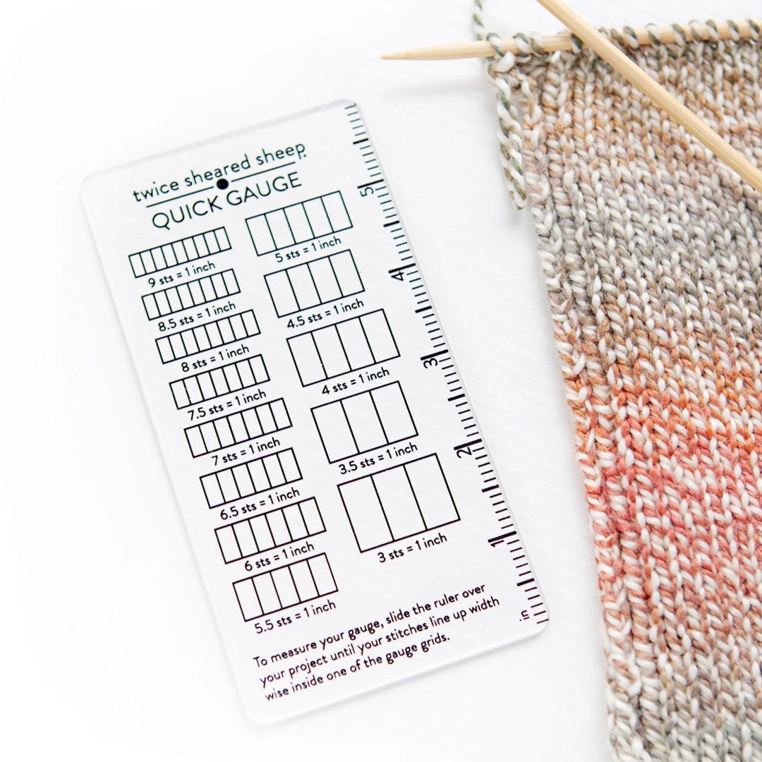 Knitting gauge chart with yarn and knitting needles on a white background
