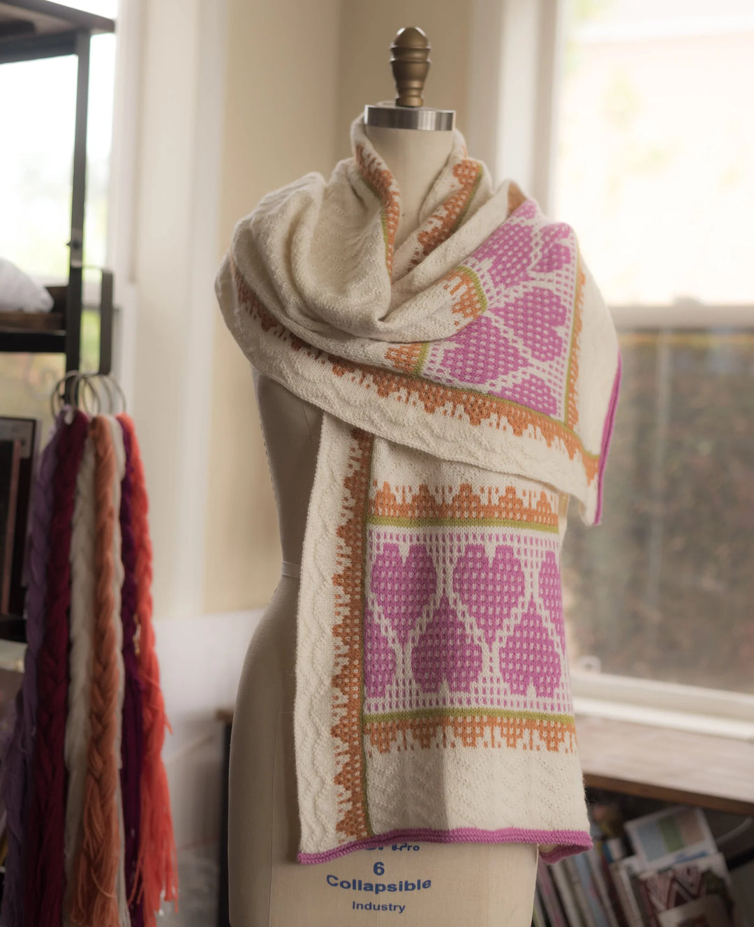 Scarf with geometric pattern on a mannequin against a neutral background