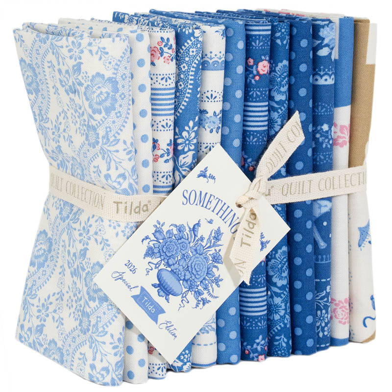 Set of blue and white patterned fabric rolls with a visible brand tag.
