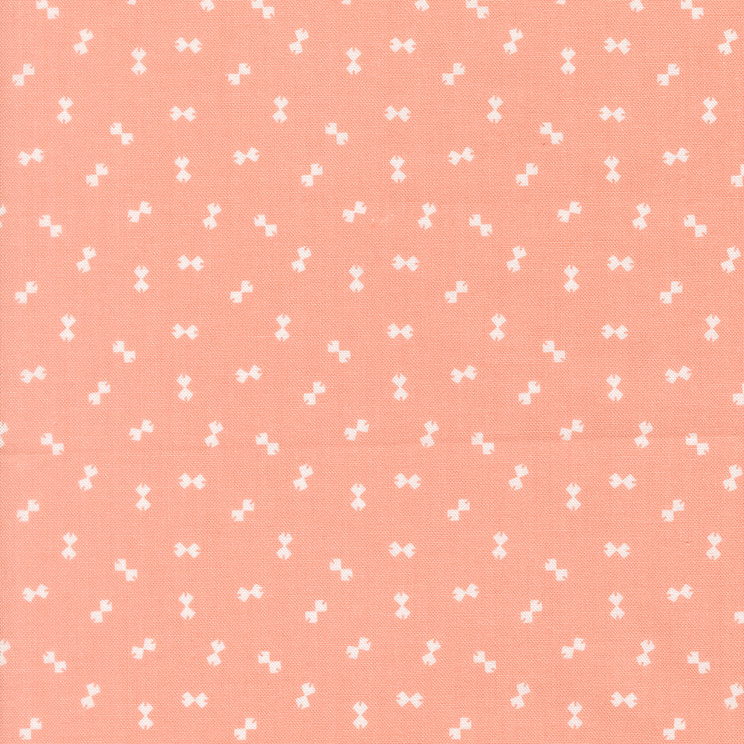 Pattern of small white bows on a pink background