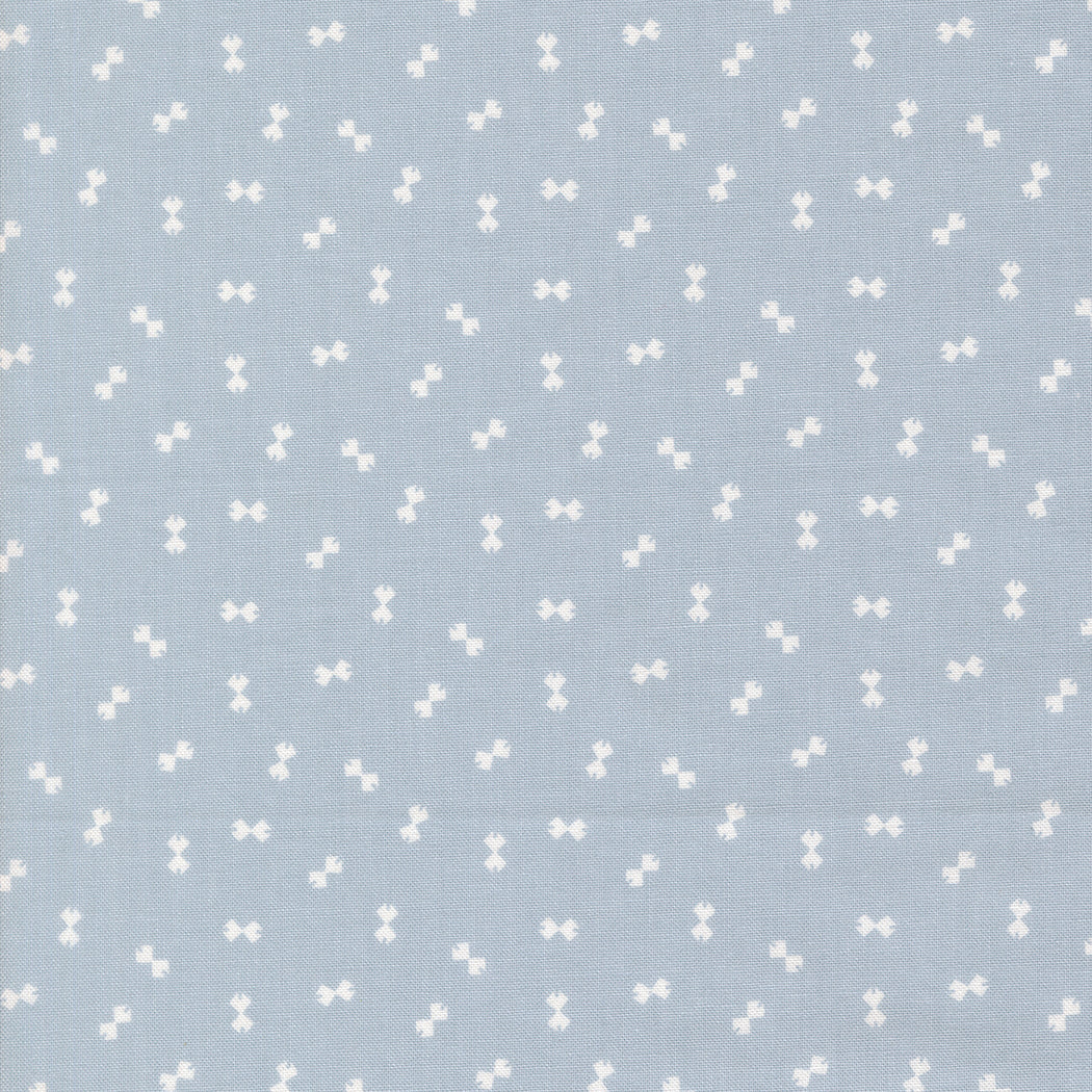 Pattern of white bows on a light blue background